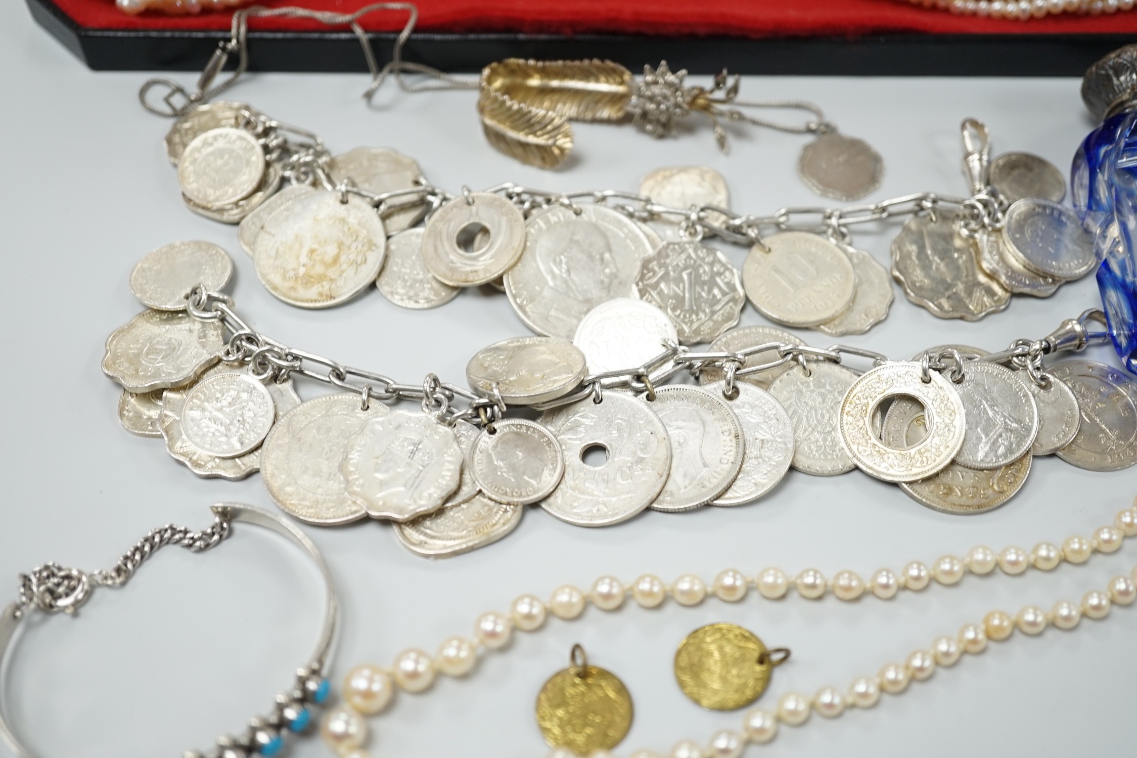 Mixed jewellery including a modern freshwater? pearl torsade necklace, 52cm, a Christian Dior 58 paste set brooch, two coin bracelets, a single strand cultured pearl necklace, mounted glass scent bottle, etc.